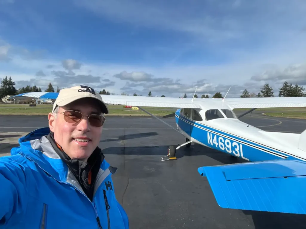 Certified flight instructor Bryan Gmyrek at Emerald Air Flight School in Arlington WA beside training aircraft